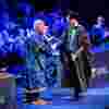 Recent graduates shakes hand with Vice Chancellor Tom Lawson.
