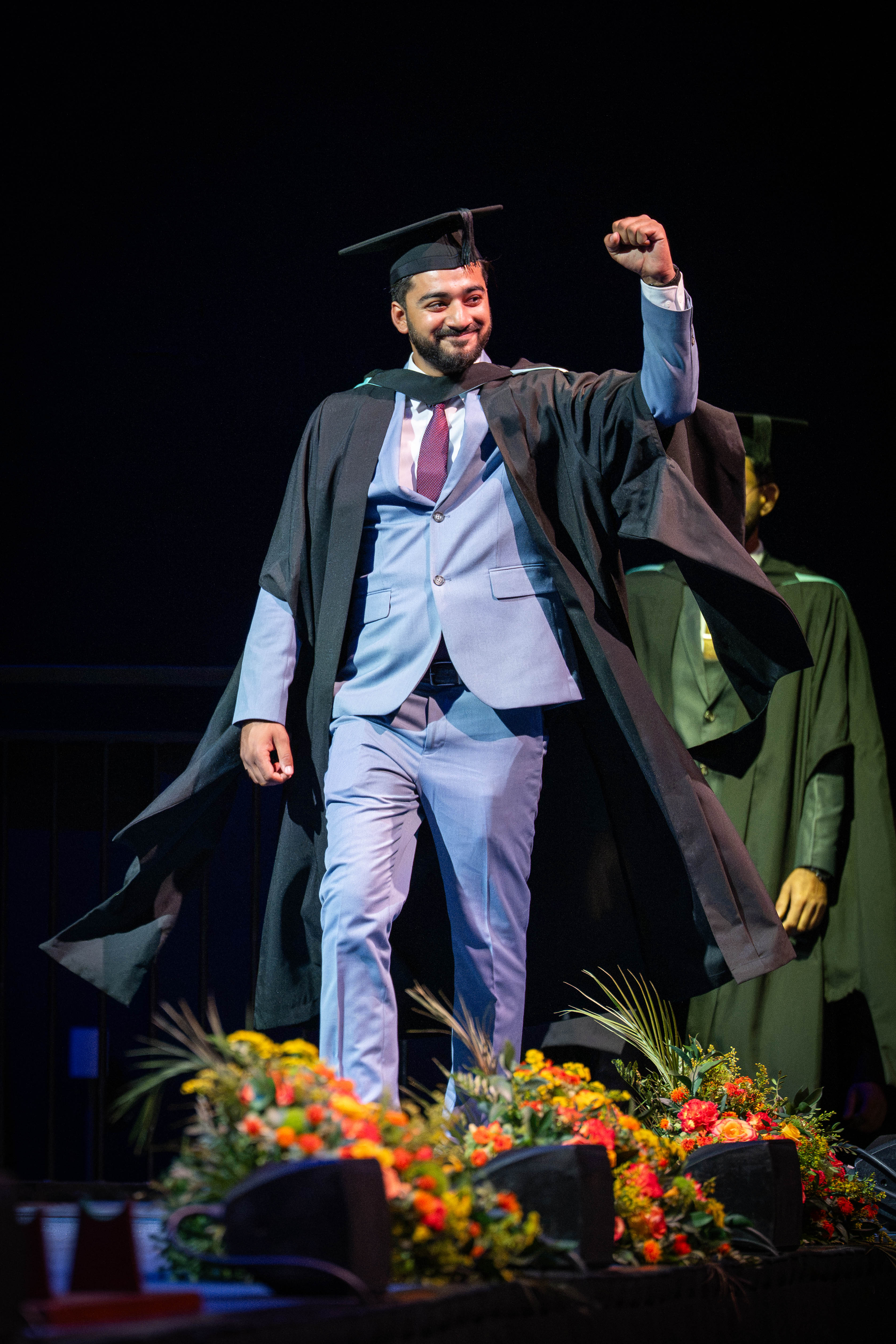 Graduate celebrates onstage. 