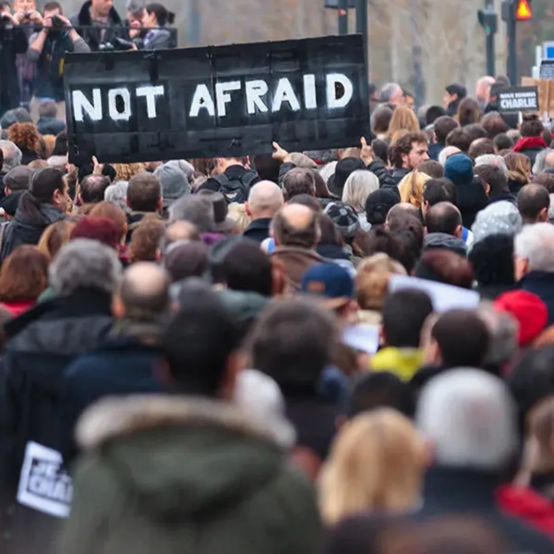 Large crowd seen with a sign saying Not Afraid