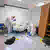 Students in a white protective suit using the crime scene lab