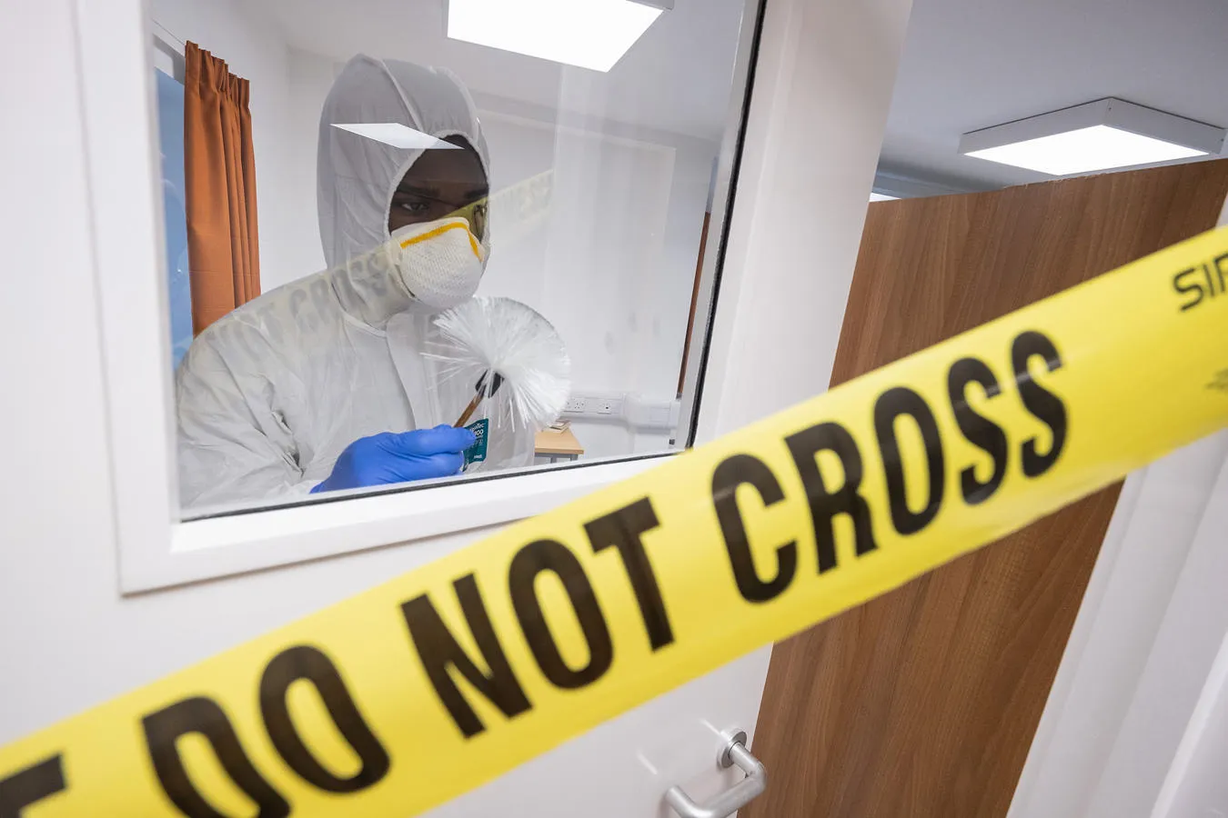 Crime scene house with do not cross banner