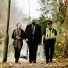 A criminology student walking down a path with two Humberside Police officers