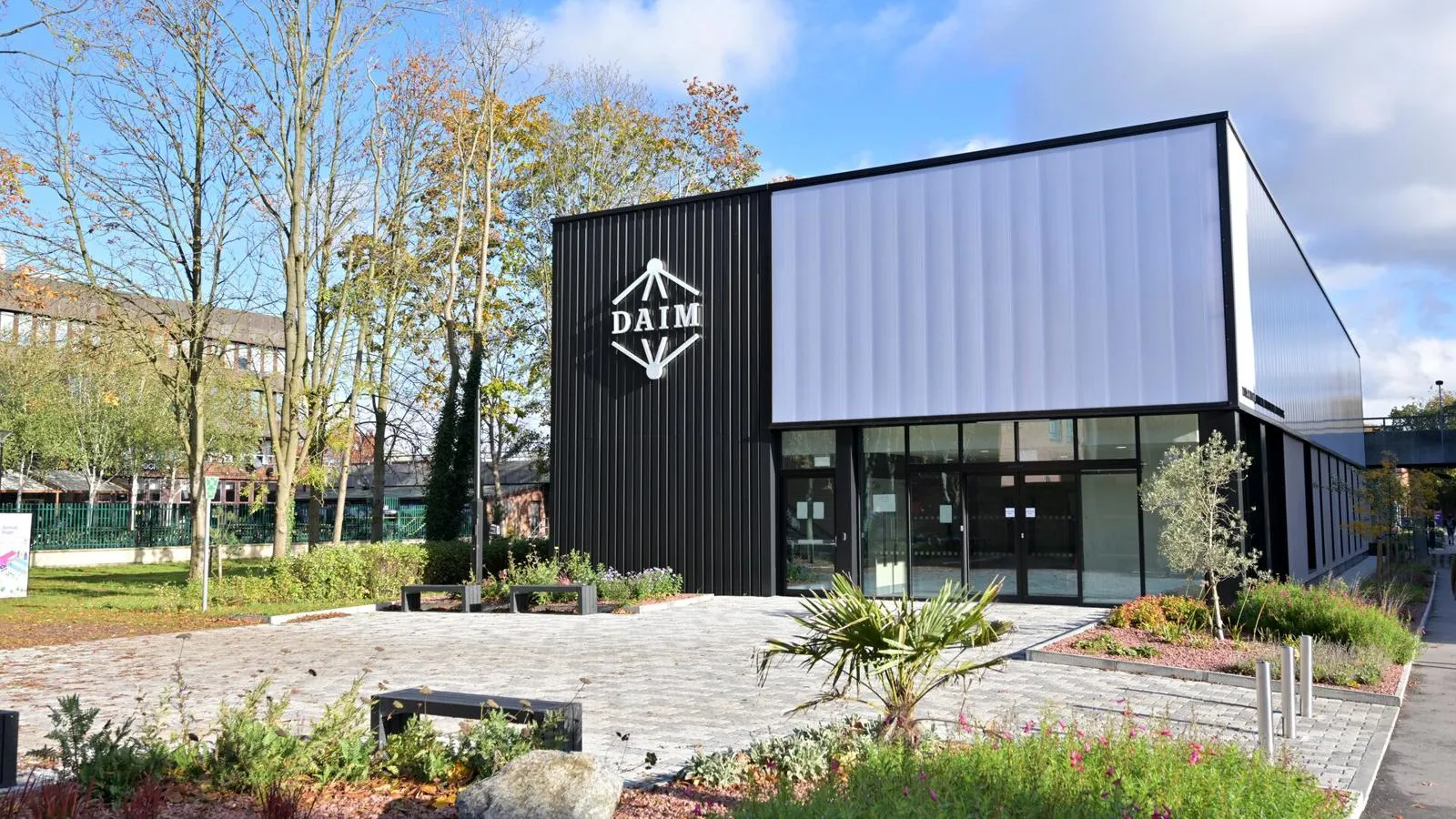 The DAIM building against a sunny backdrop on campus.