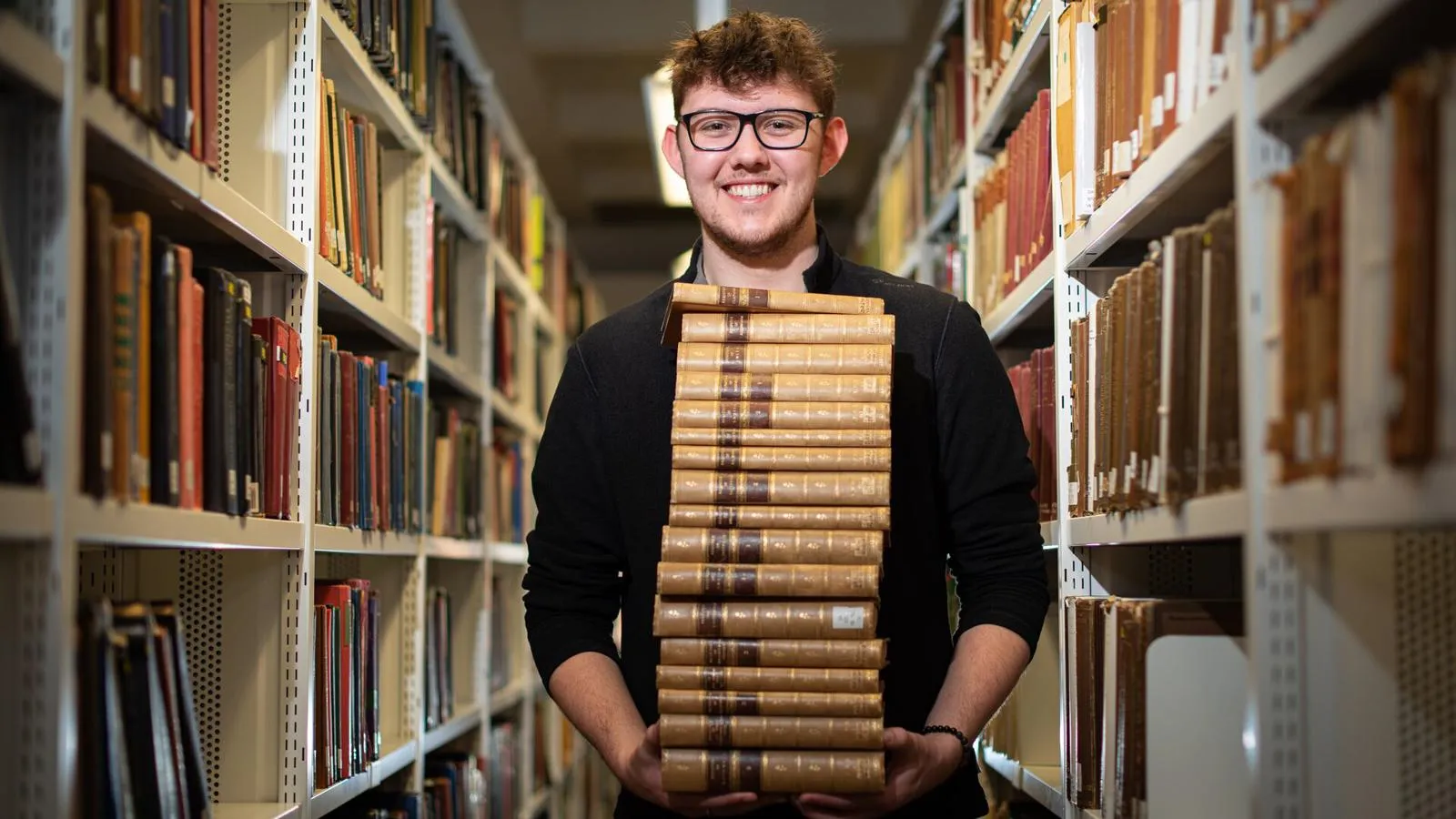 student holding books