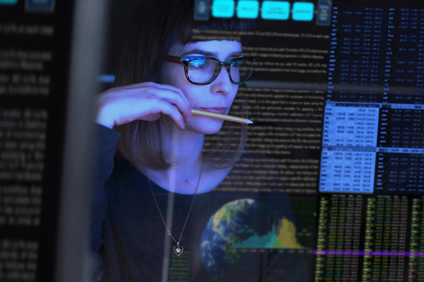 A reflection of a student reading mathematical equations on a digital screen