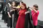 Student getting robe fitted for graduation