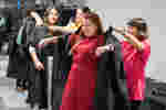 Student getting robe fitted for graduation