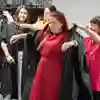 Student getting robe fitted for graduation