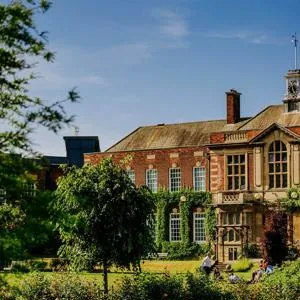 Students walk past the front of one of the University's grade 2 listed buildings