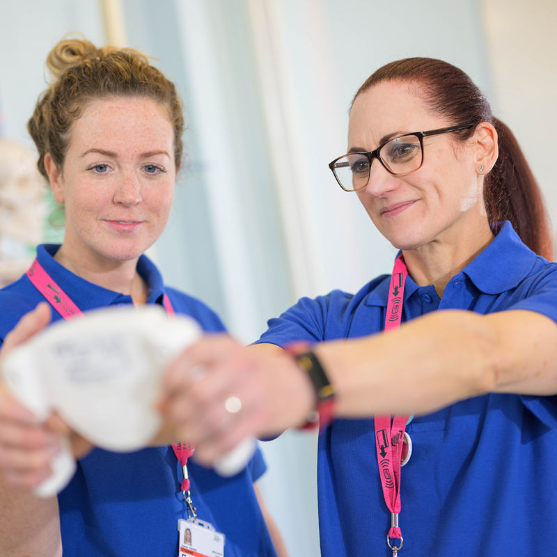 Nutrition students taking a reading from equipment.