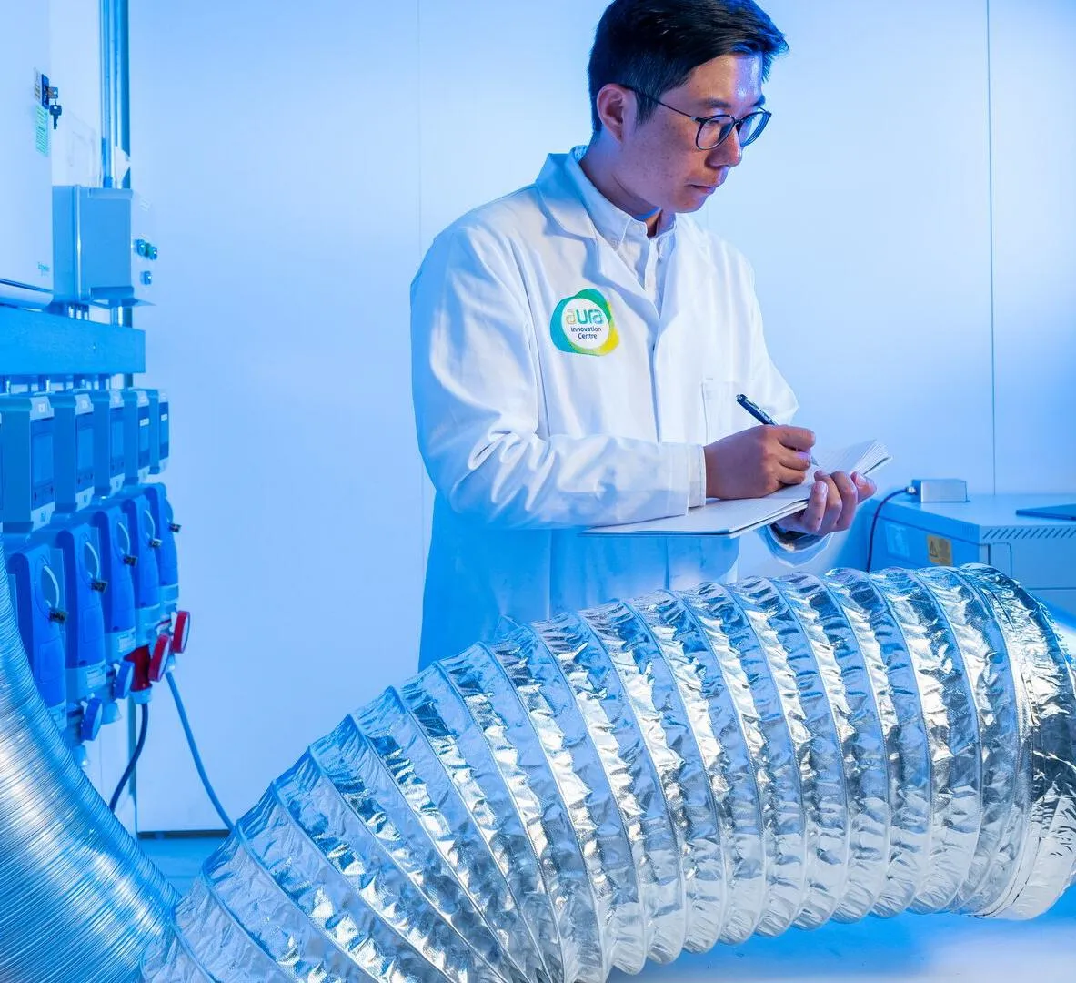 Researcher in a lab coat doing an experiment