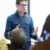 A teacher exclaiming with his hands