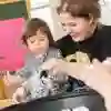 An education student in the classroom with child