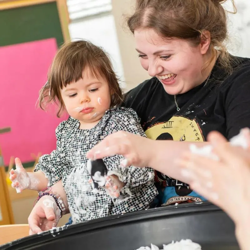 An education student in the classroom with child