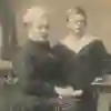 A Victorian-era sepia image of an older woman with a boy