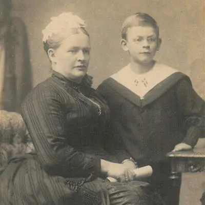 A Victorian-era sepia image of an older woman with a boy