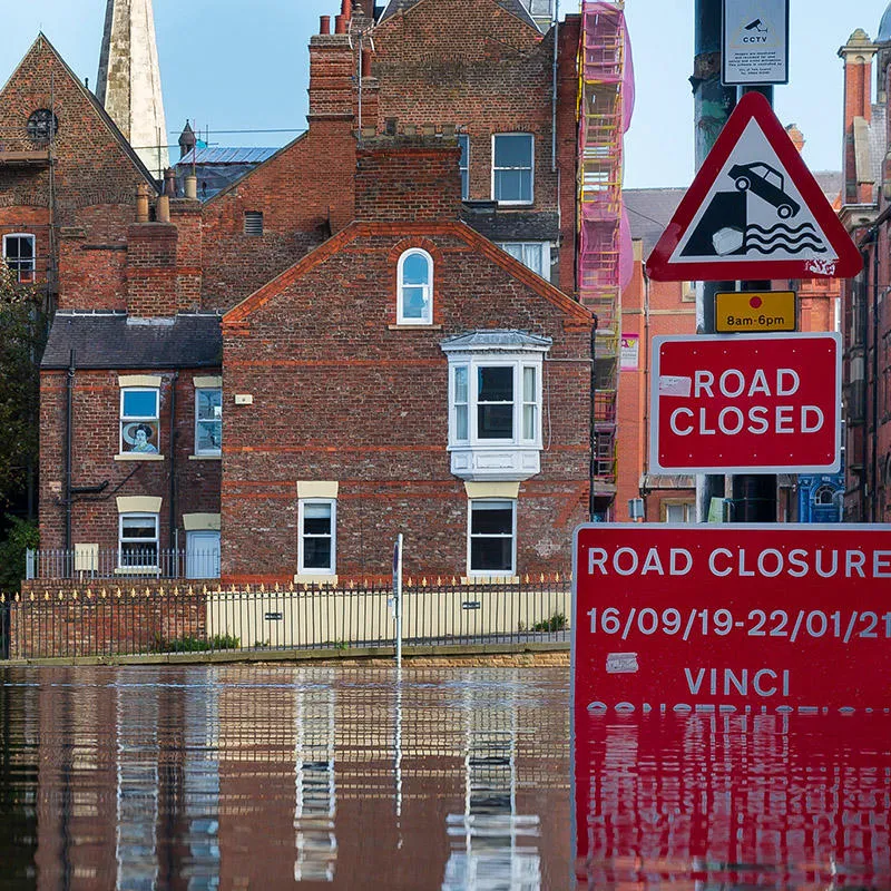 Flooded street with submerged road closed sign