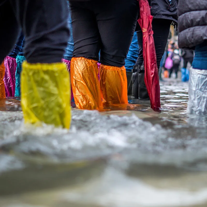Colourful wellies, ankle deep in flood water