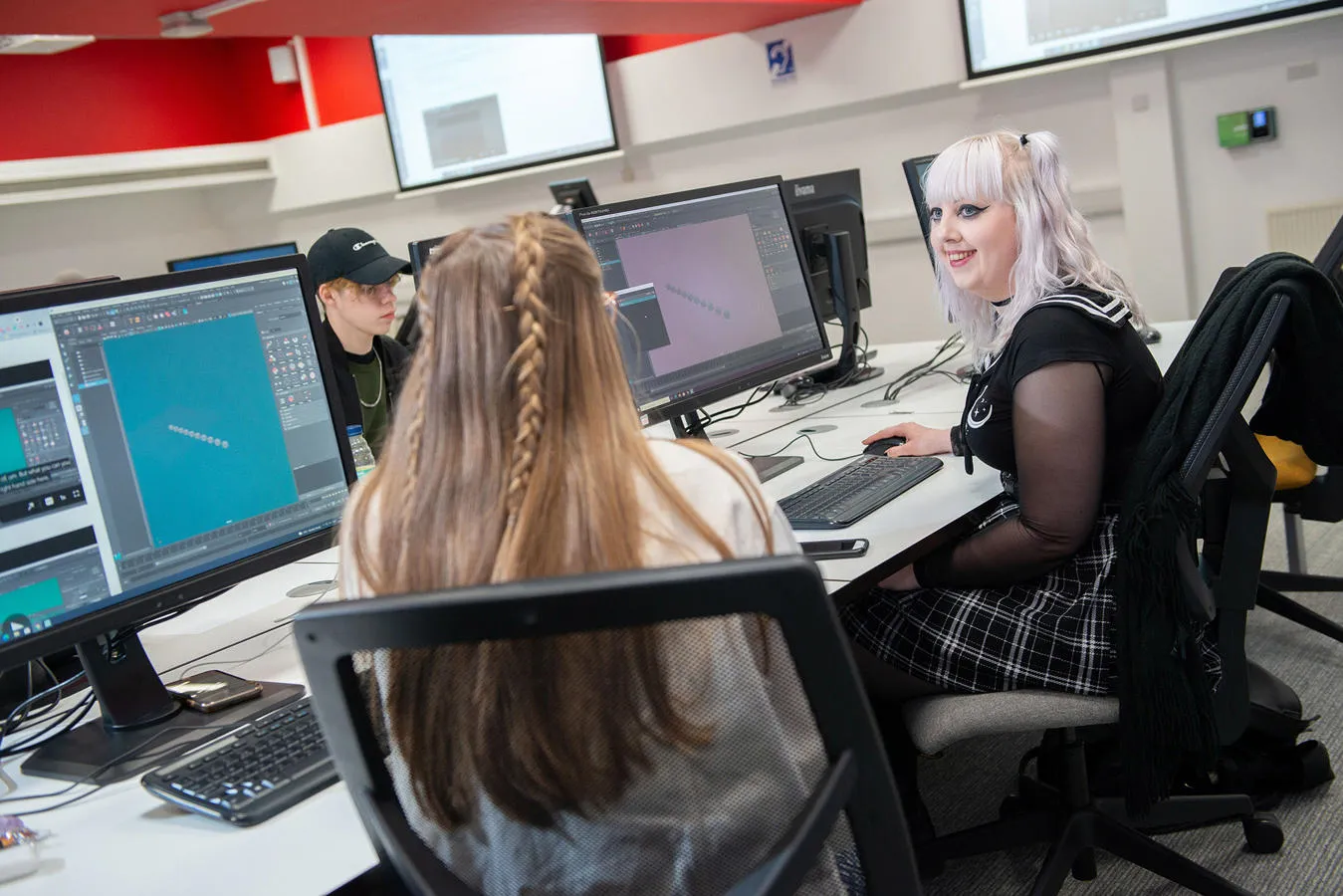 Three students working at computers