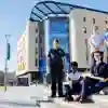 A group of students from different health courses stood outside the Allam Medical Building in uniform
