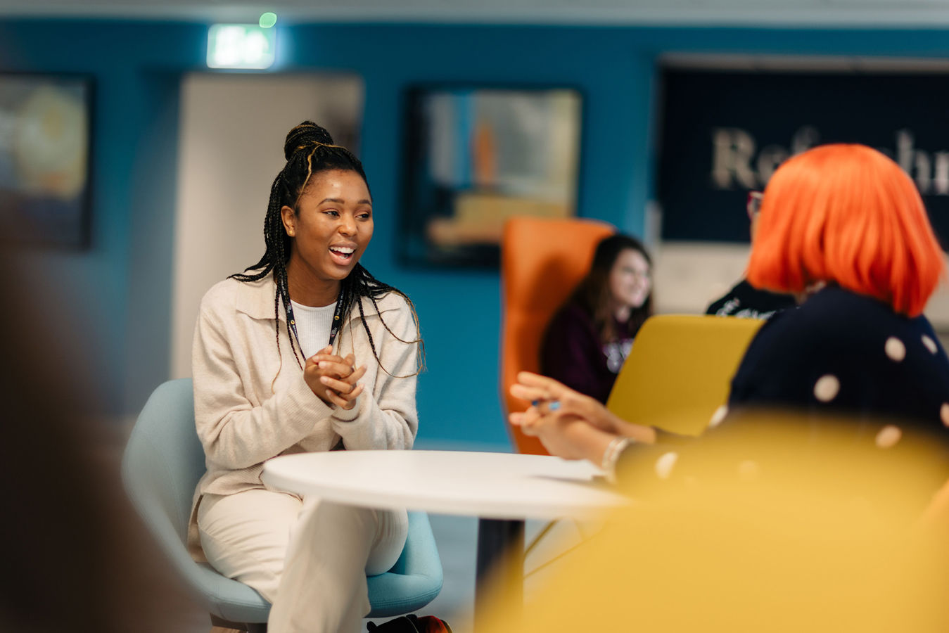 Students sat at tables in the Business Lounge