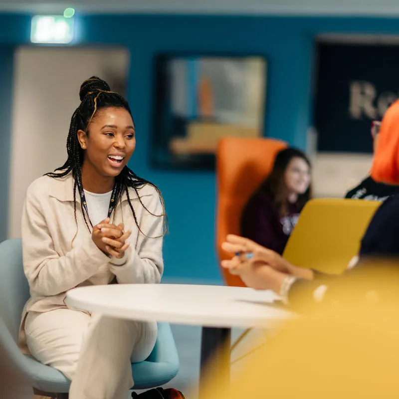 Students sat at tables in the Business Lounge