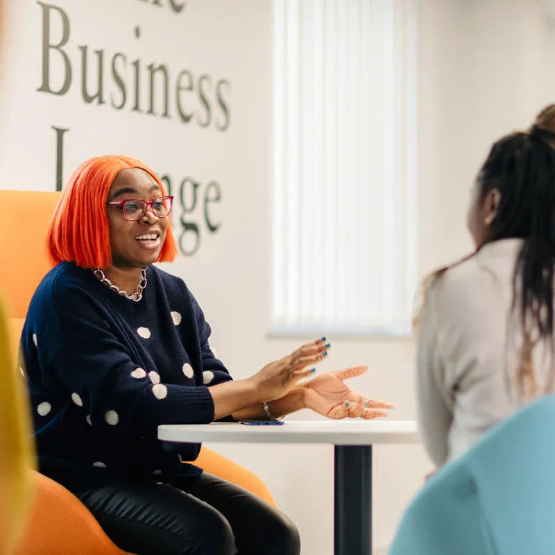 Students talk in the Business lounge on campus