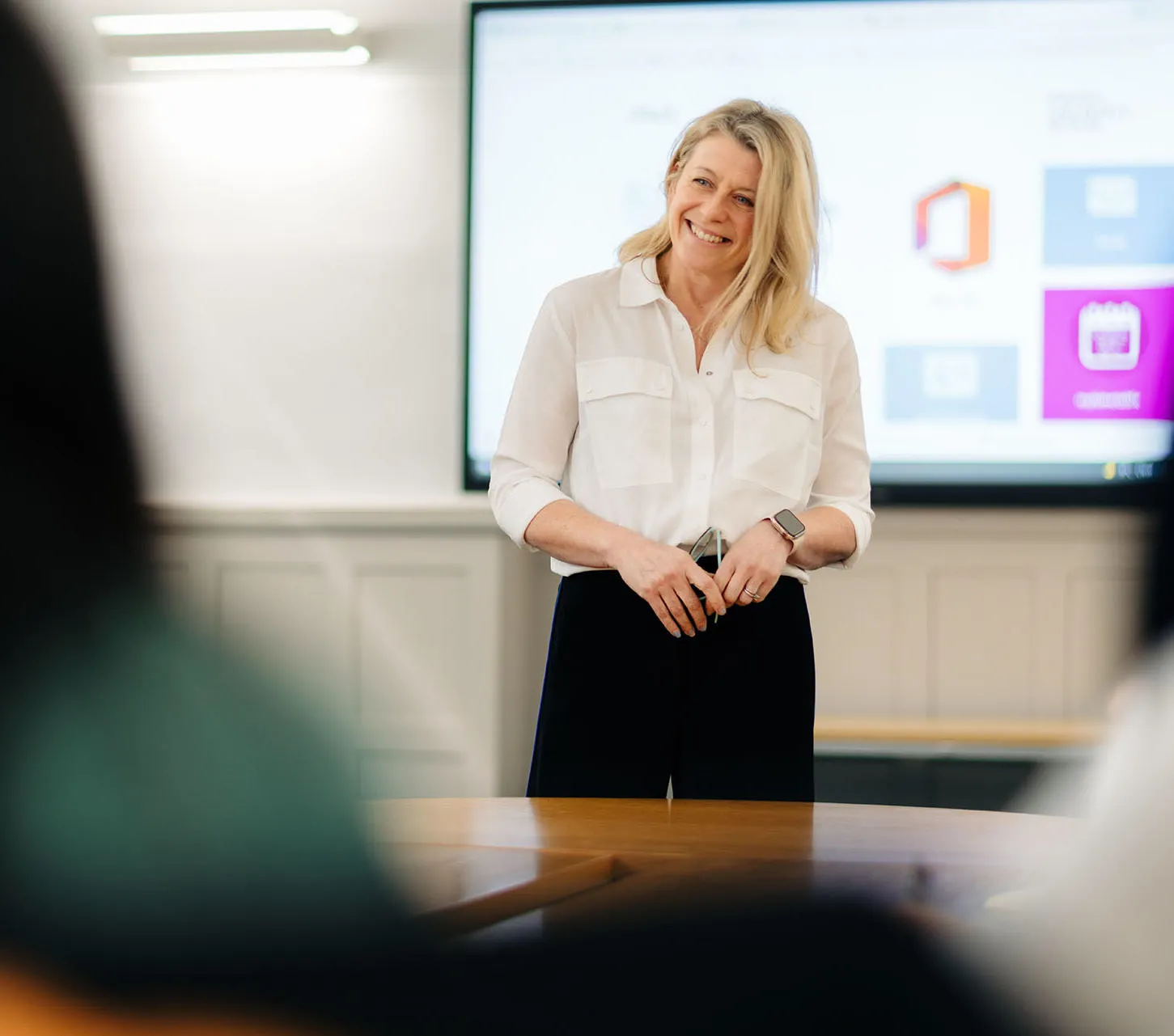 An educator presents in the executive education suite