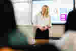 An educator presents in the executive education suite