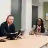 Two people sat at a desk in the legal advice centre