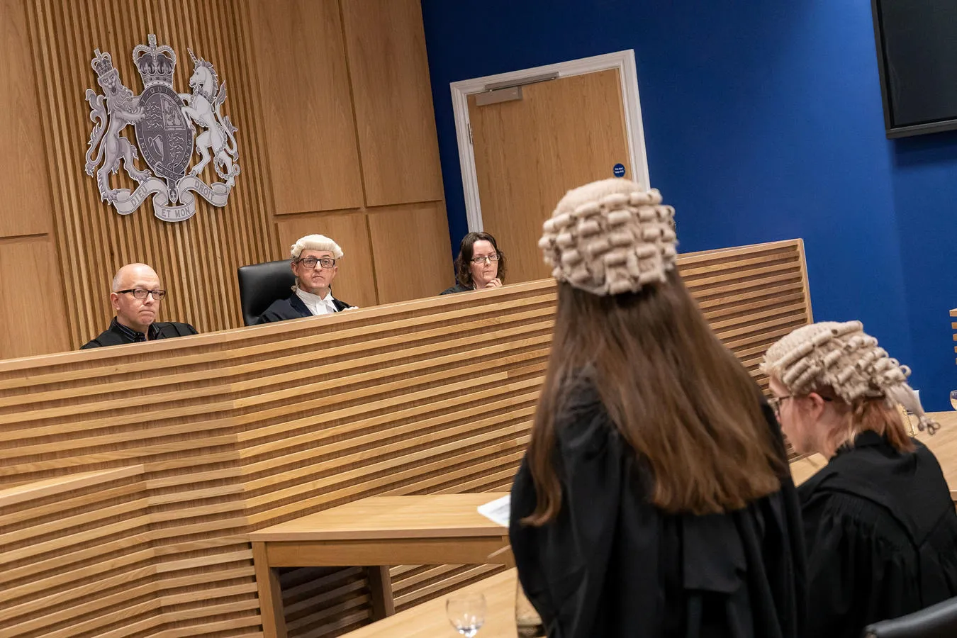 Mock courtroom trial with interaction between judge and barrister