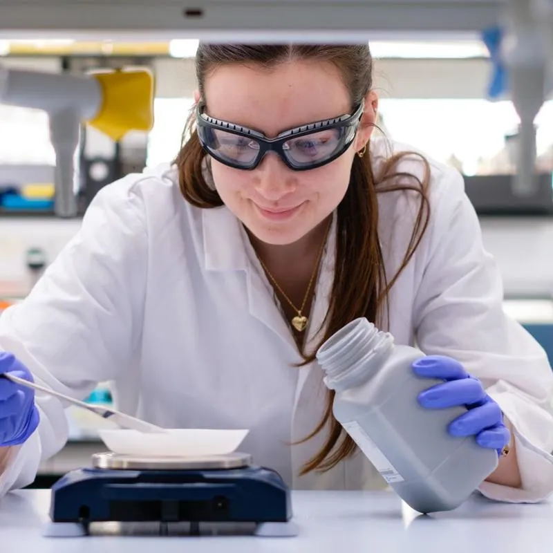 Researcher performing an experiment in a lab