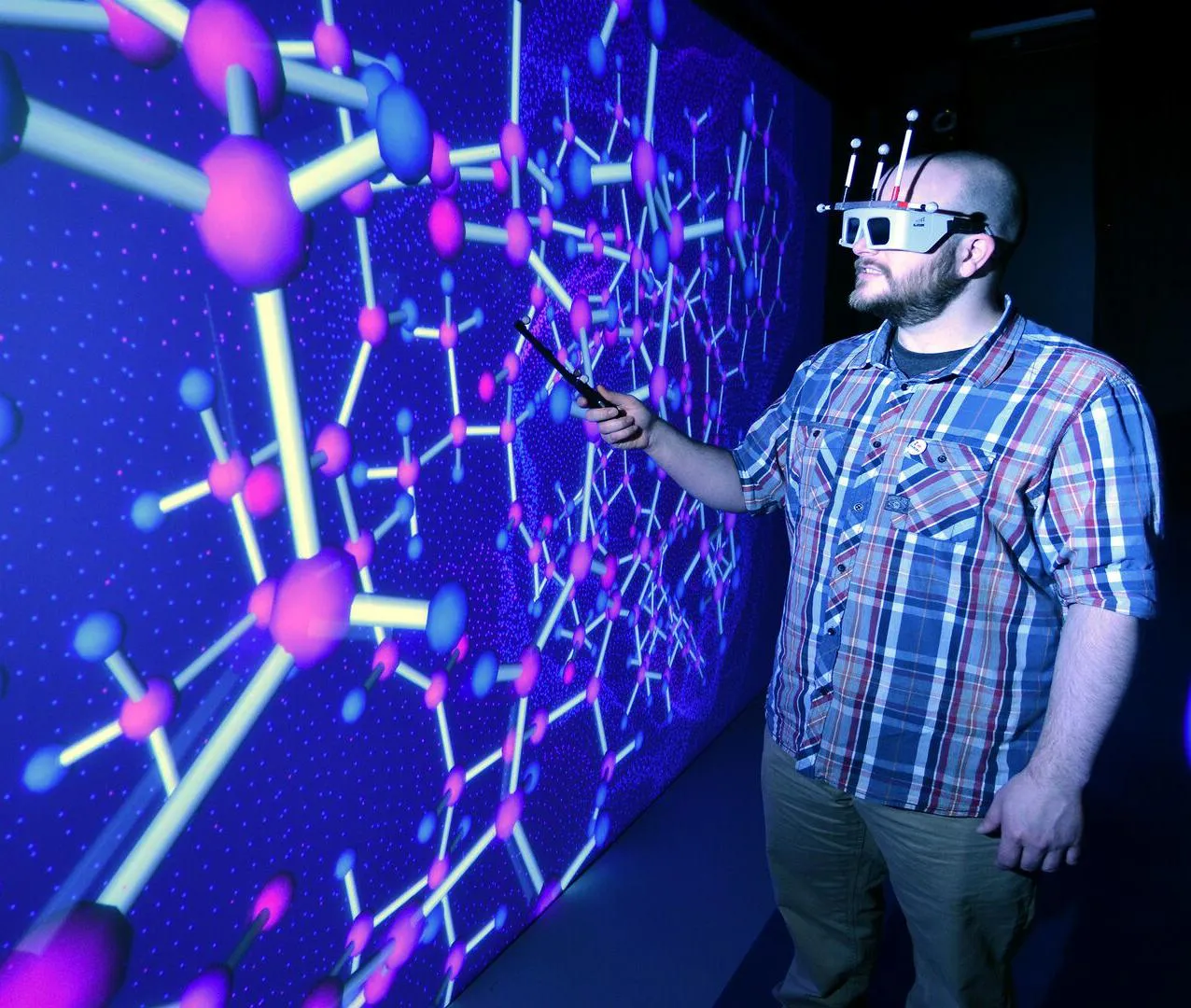 A student wearing a virtual reality headset working in the HIVE room