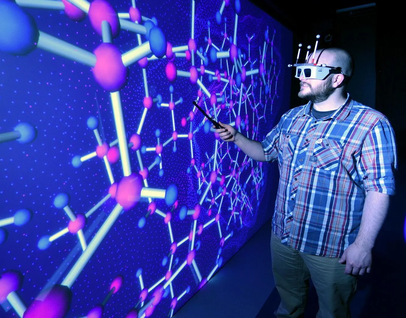 A student wearing a virtual reality headset working in the HIVE room