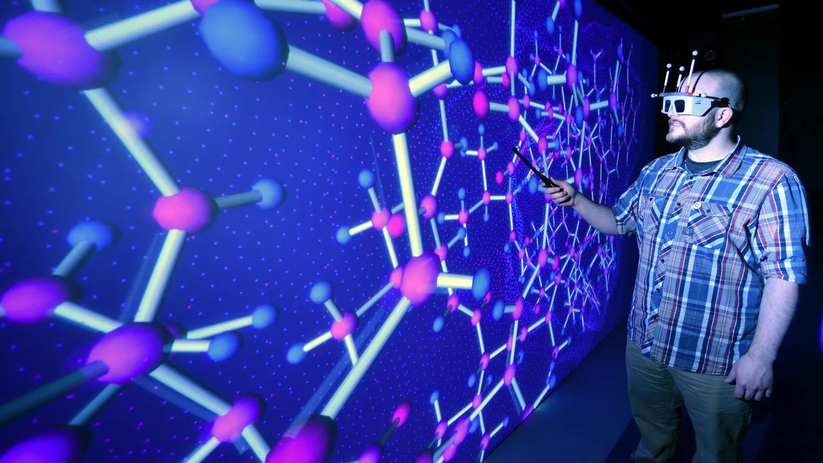 A student wearing a virtual reality headset working in the HIVE room