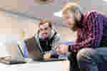 Students looking at laptops