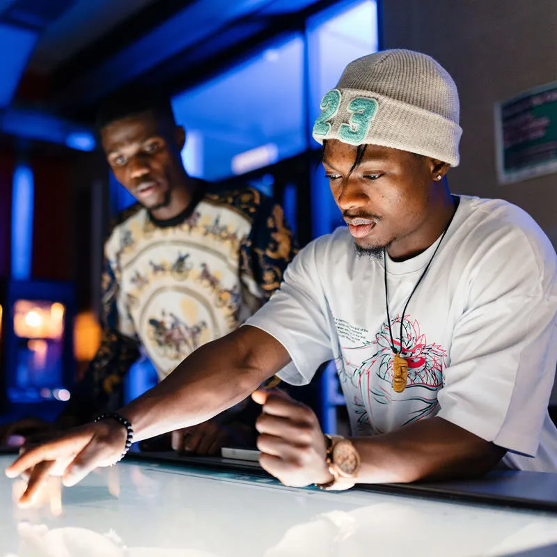A group of students using a large touch screen tablet