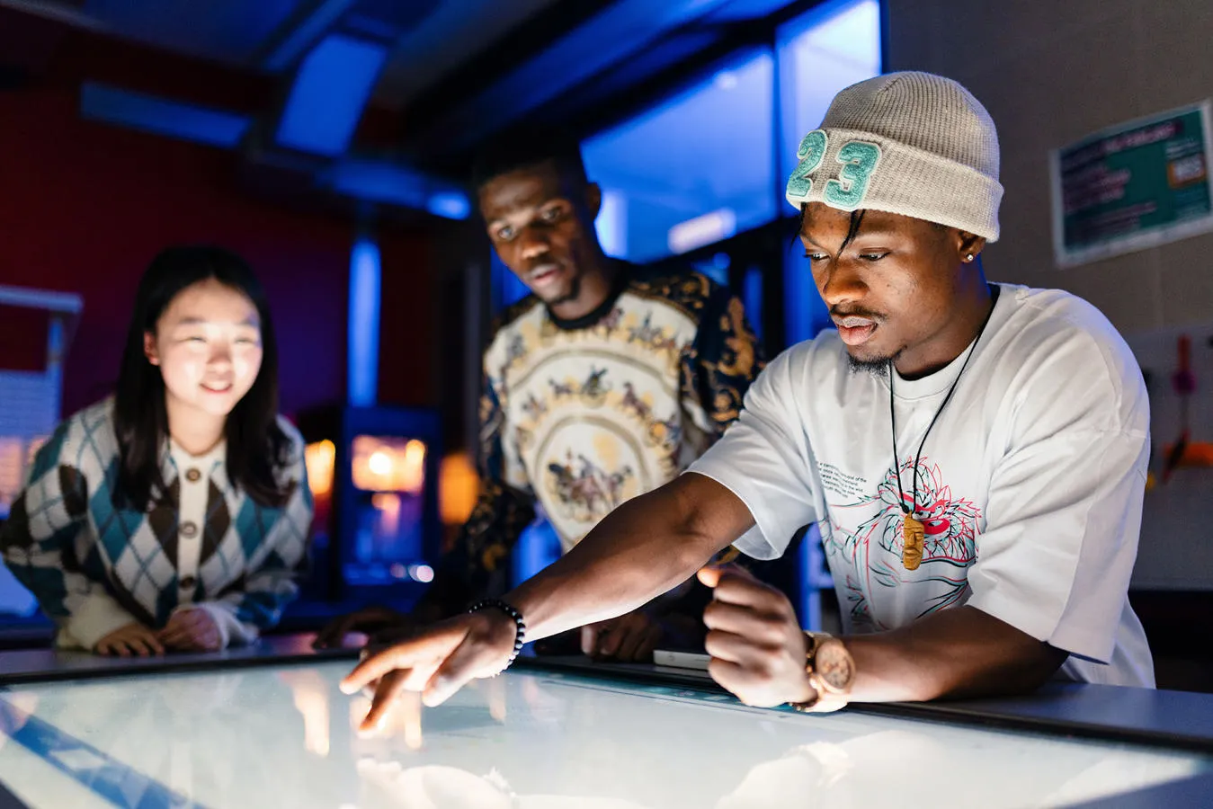Students working on a touch-screen desk