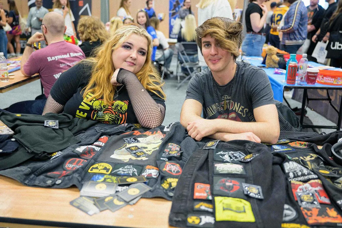 two students at a freshers fair stand promoting thier society