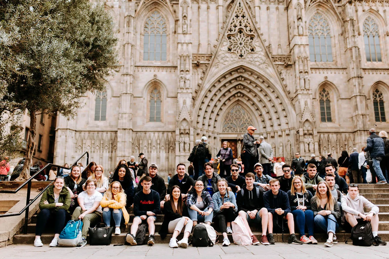 Geography students pictured on cathedral steps on a field trip in Barcelona