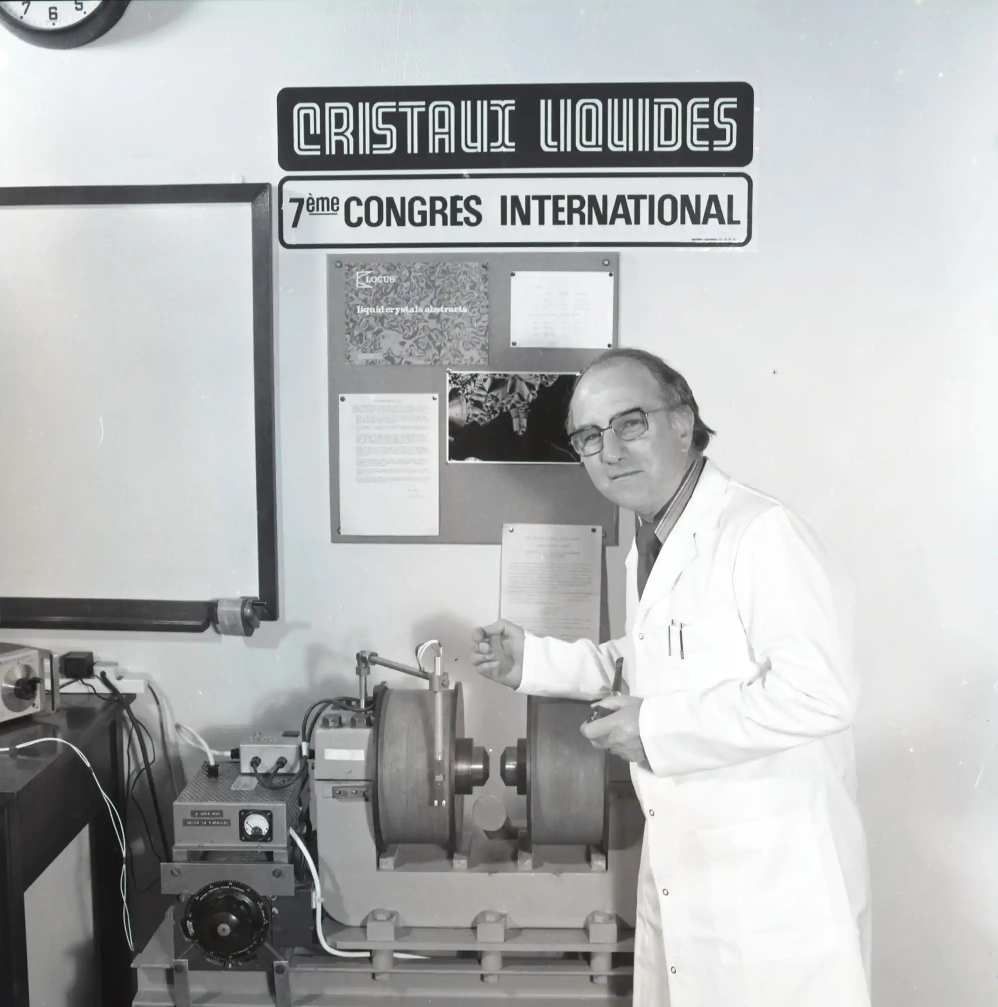 Professor George Gray standing in front of a display demonstrating liquid crystal technology