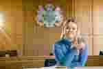 Law student Gerogia Sykes sits smiling in one of the University's mock court rooms.