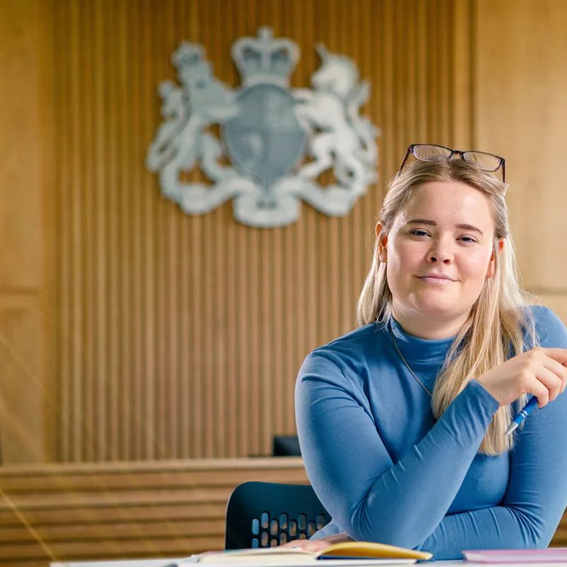 A law student sat in a mock courtroom