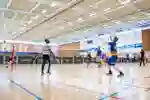 Badminton in the large sports hall at a 'Give it a go' event