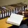 An open book on a table of files.