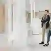 Two students stand alongside each other look at an exhibit in a gallery