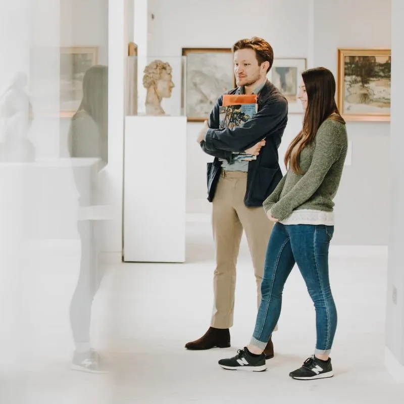 Ethan Harding and Evelyn Rose walk amongst historical sculptures in our Art Gallery