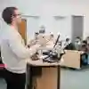 A lecturer speaking to a small room of people