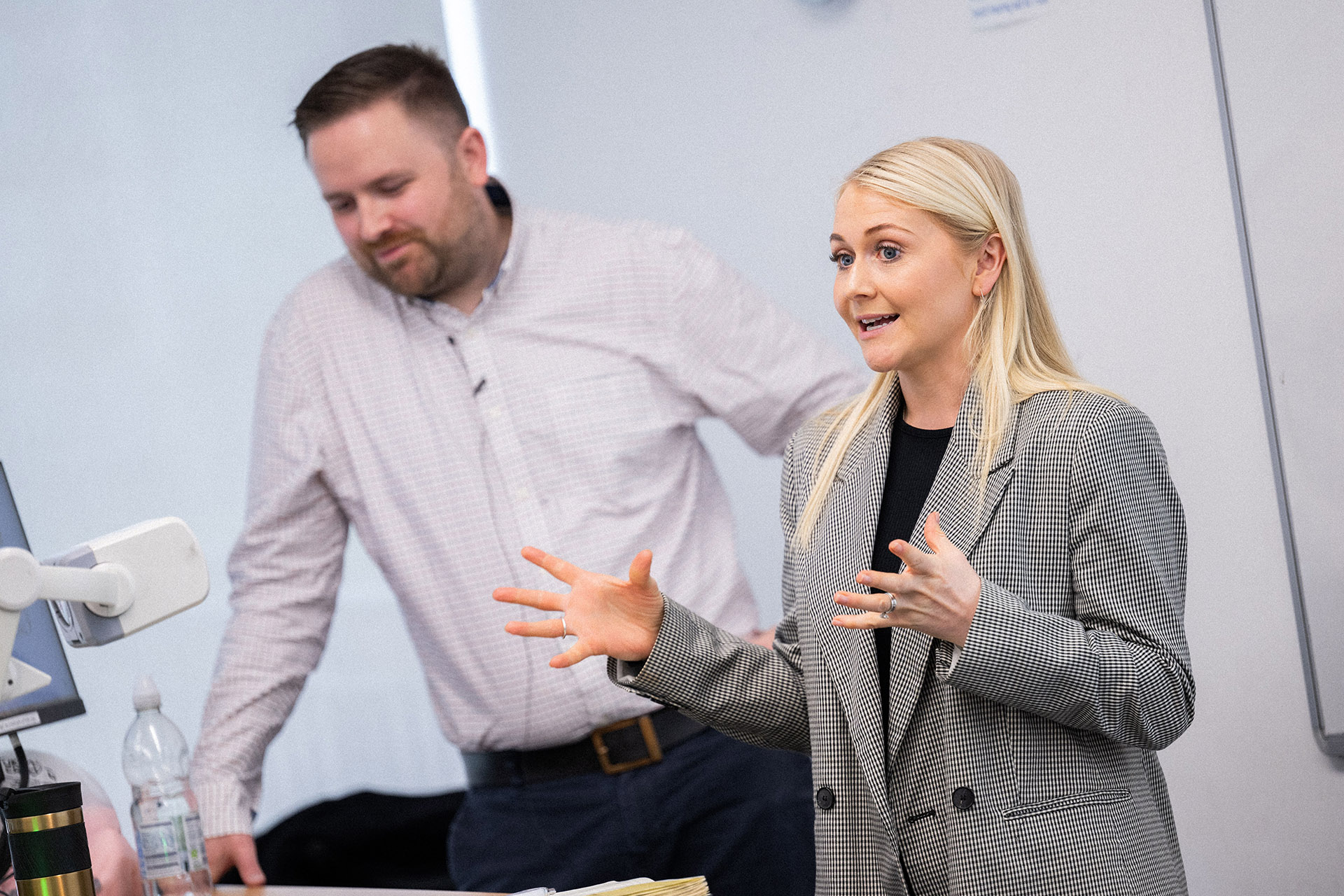 A speaker presents a talk while another person looks on