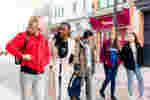5 students walking down Humber street while Talking.